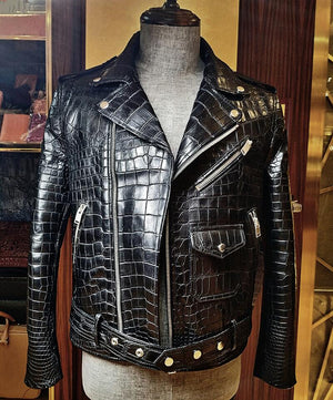 Black crocodile skin leather jacket on a mannequin against a wooden background