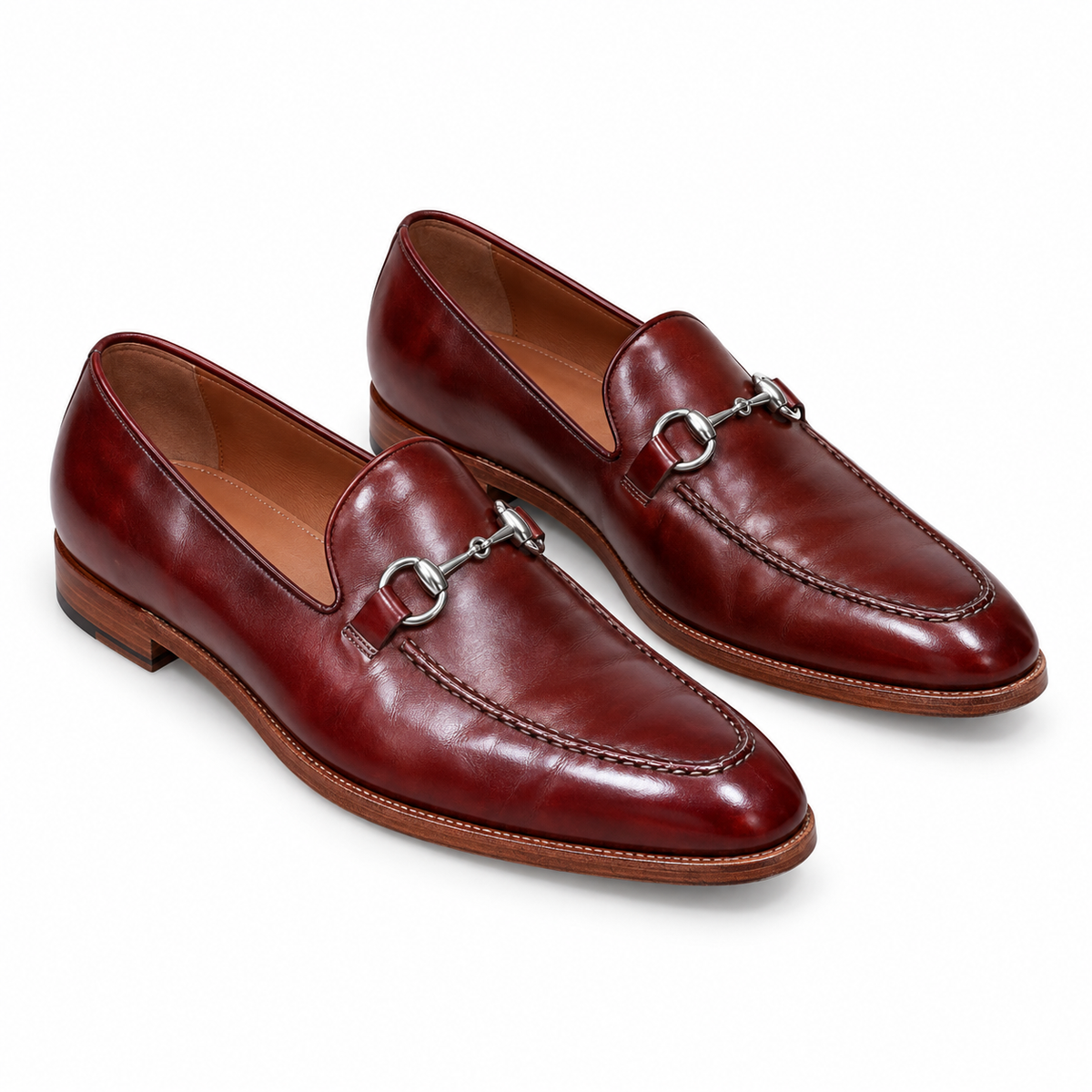 Pair of men's burgundy leather horsebit loafers with silver bit, three-quarter view