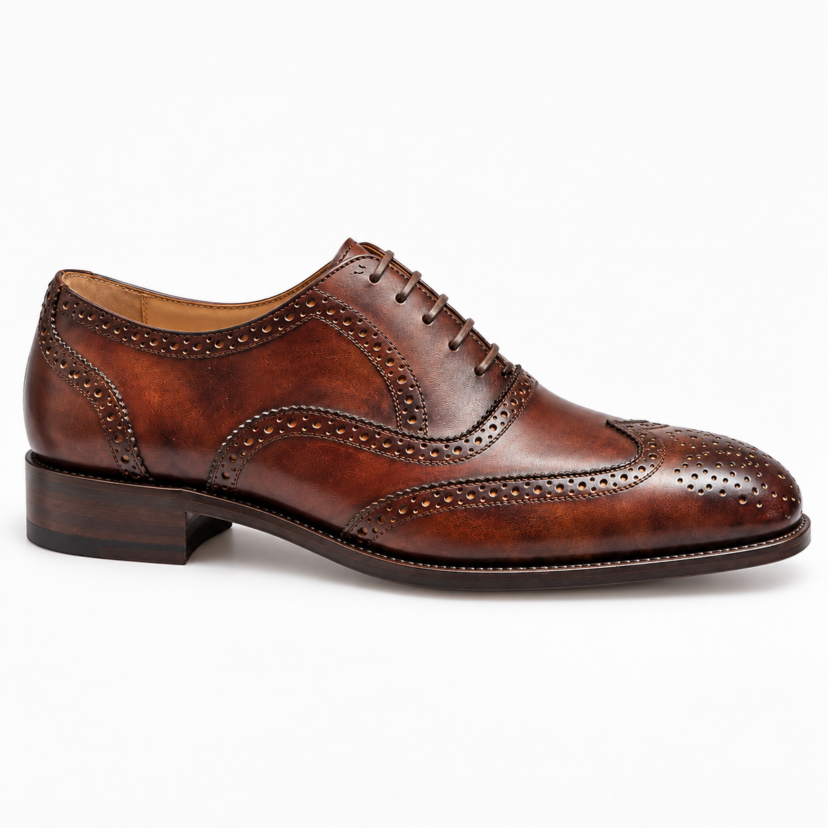 Men's tan wingtip brogue, side profile showing the burnished leather and broguing