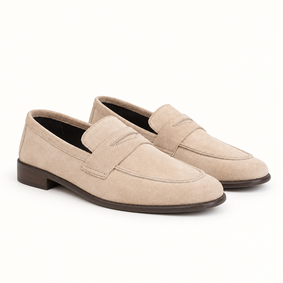 Pair of men's stone suede penny loafers in sand beige, three-quarter view