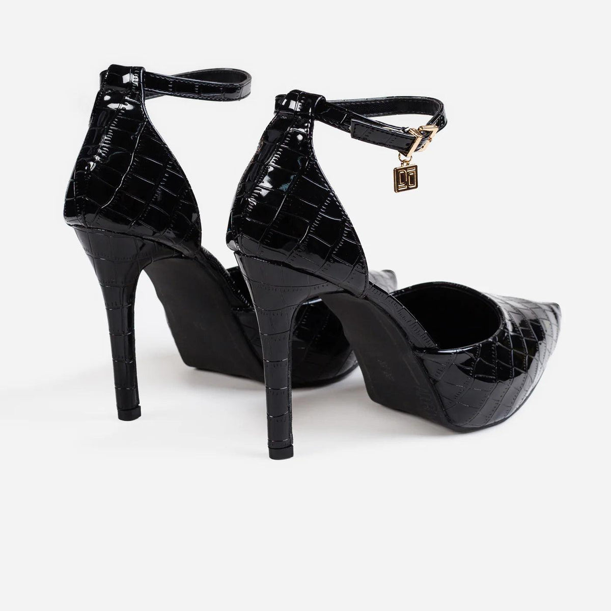 Pair of Hologlam black stiletto pumps, back view of the heels and straps