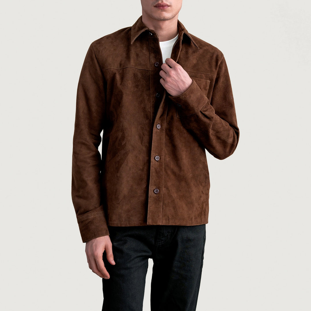 Full-length view of a man wearing a mocha brown suede leather shirt jacket over a white t-shirt with black jeans.