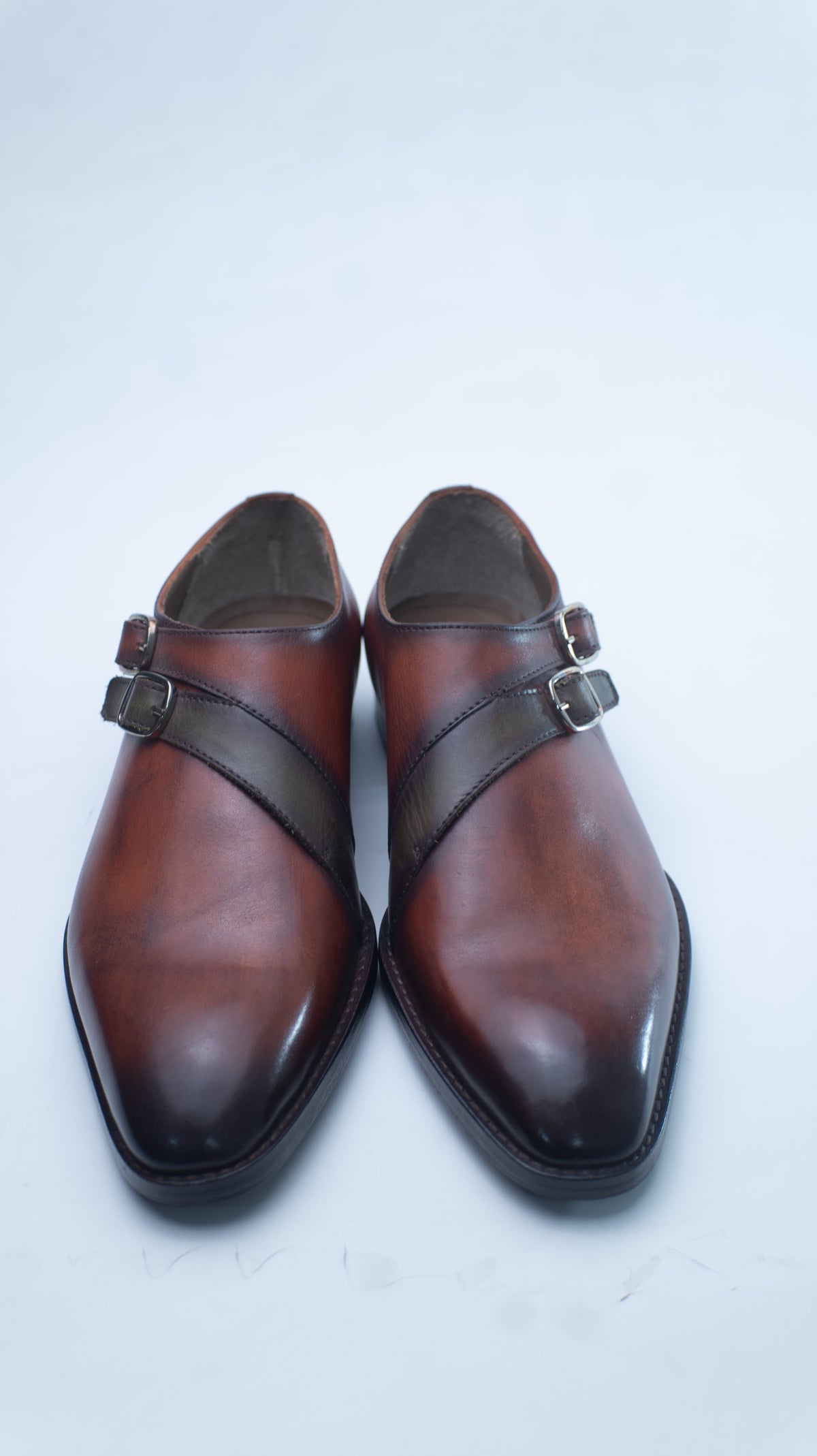 Pair of antique brown patina monk strap shoes, top-down view