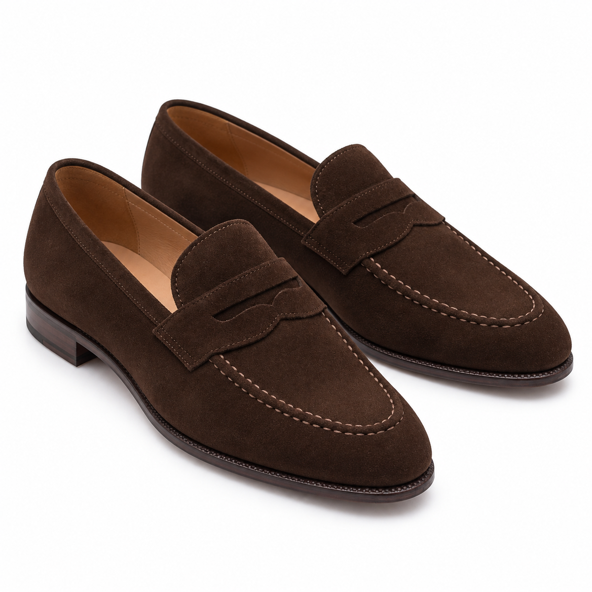 Pair of men's dark brown suede penny loafers, three-quarter view