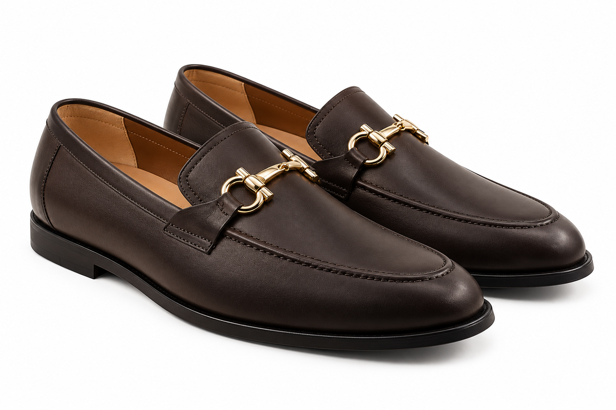 Pair of men's handcrafted dark brown leather loafers with gold horsebit, three-quarter view
