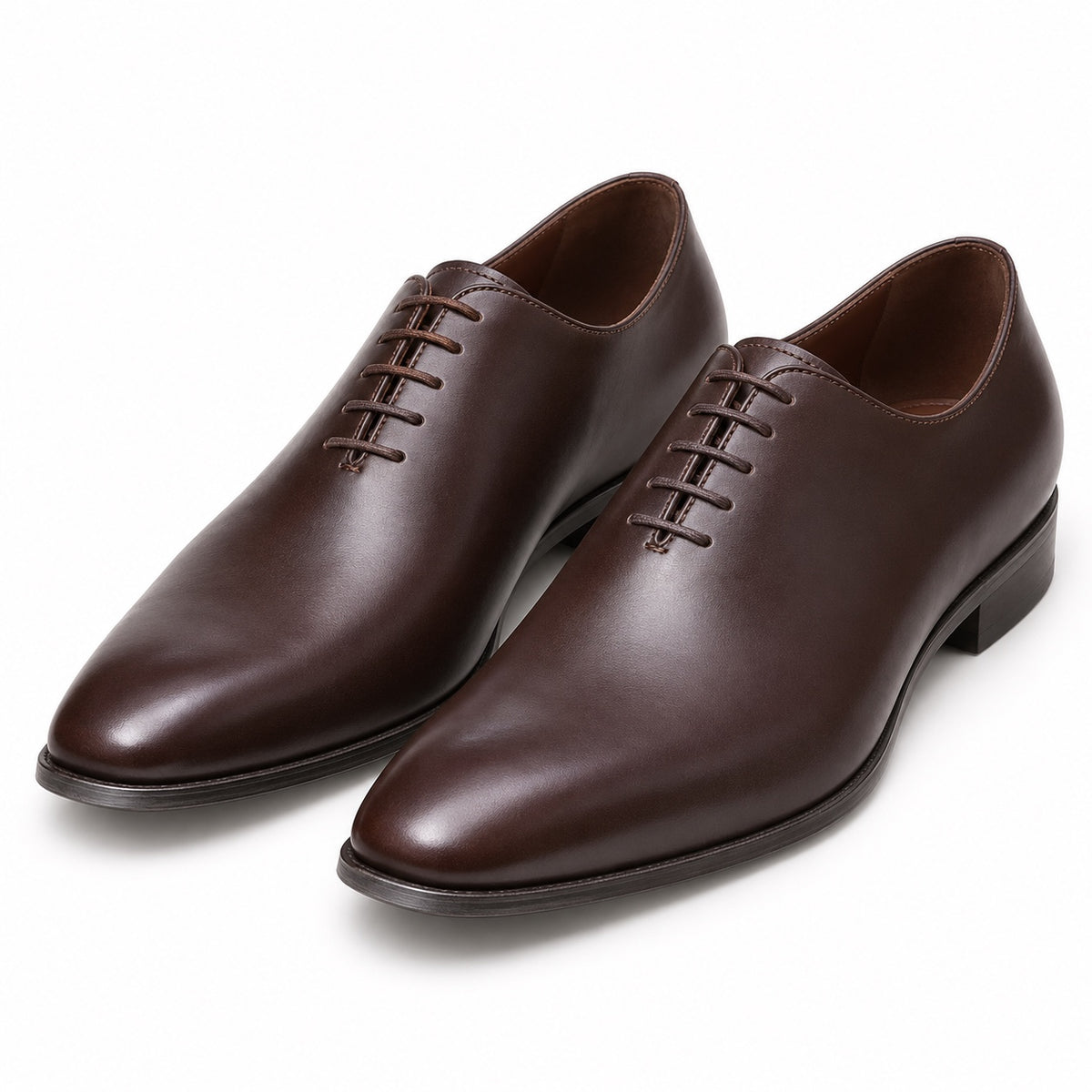 Pair of men's dark brown wholecut oxford shoes in smooth leather, three-quarter view